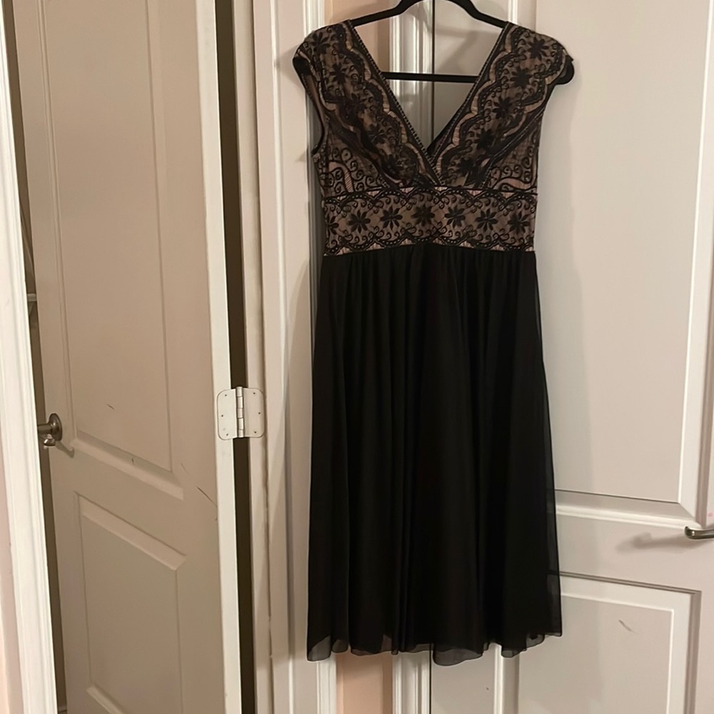 Black midi dress. Flows at bottom. Beige with black lace on top part.